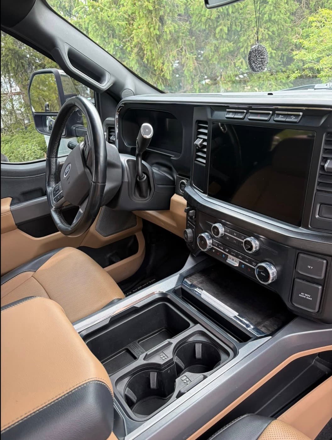 Clean tan and black leather interior of a Ford Super Duty after a full interior detail